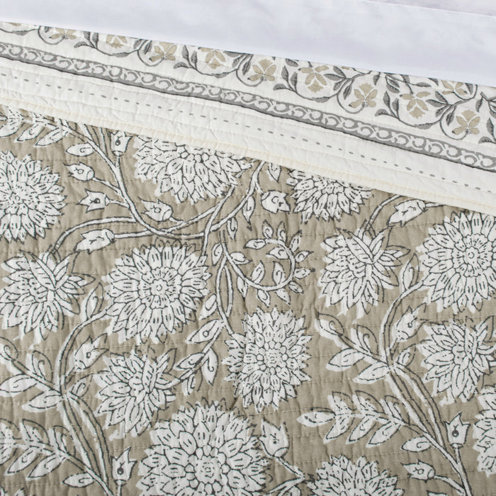Floral patterned fabric with white flowers on a beige background