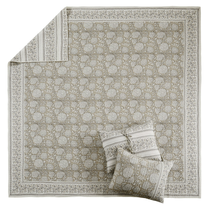 Decorative rug with intricate patterns and matching pillows on a white background