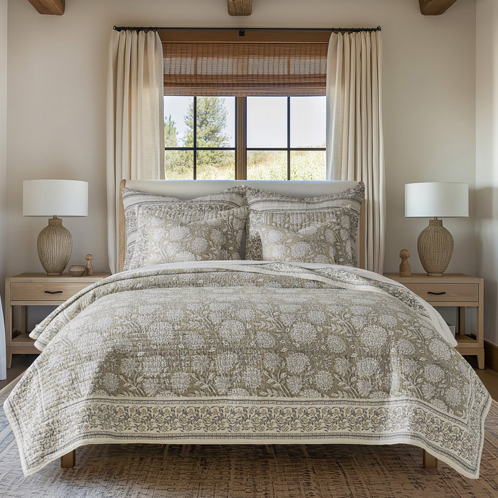 Bedroom with floral-patterned bedding, nightstands, and lamps.