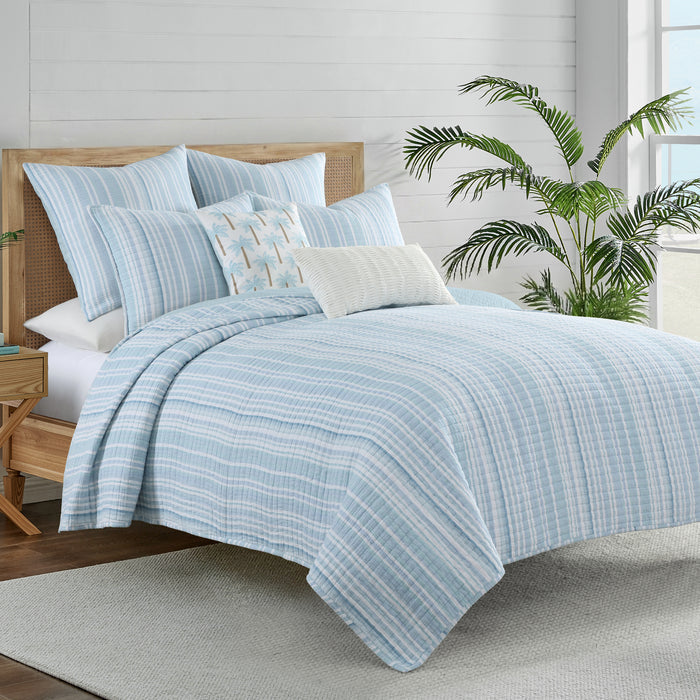 Boracay Stripe Muslin Quilt Set on a bed, featuring an airy striped pattern in soothing aqua and seafoam shades.