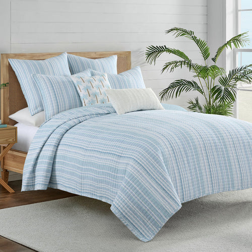 Boracay Stripe Muslin Quilt Set on a bed, featuring an airy striped pattern in soothing aqua and seafoam shades.