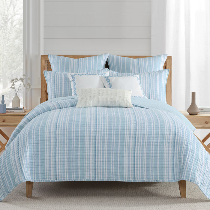 Boracay Stripe Muslin Quilt Set displaying a coastal style with aqua and seafoam stripes on a bed.