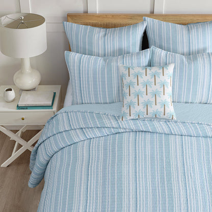 Boracay Stripe Muslin Quilt Set in soothing aqua and seafoam shades, styled with decorative pillows.