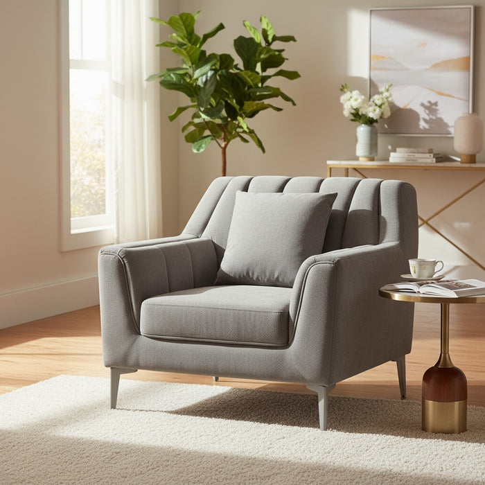 Modern gray armchair with tufted back, cushion, and metal legs in cozy living room setting