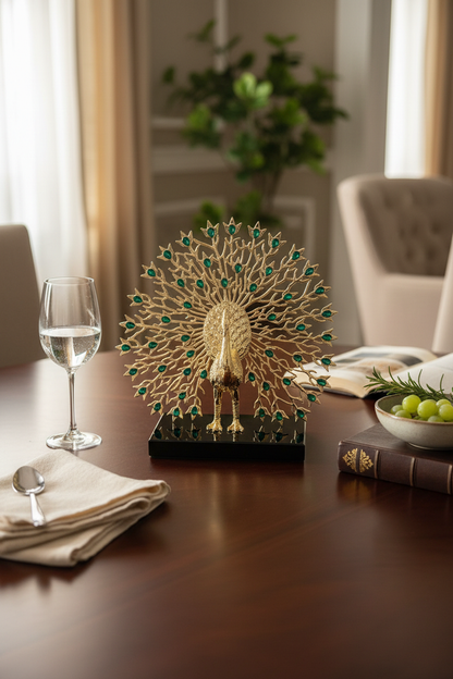 Golden peacock sculpture with green gem accents on dining table, elegant home decor piece