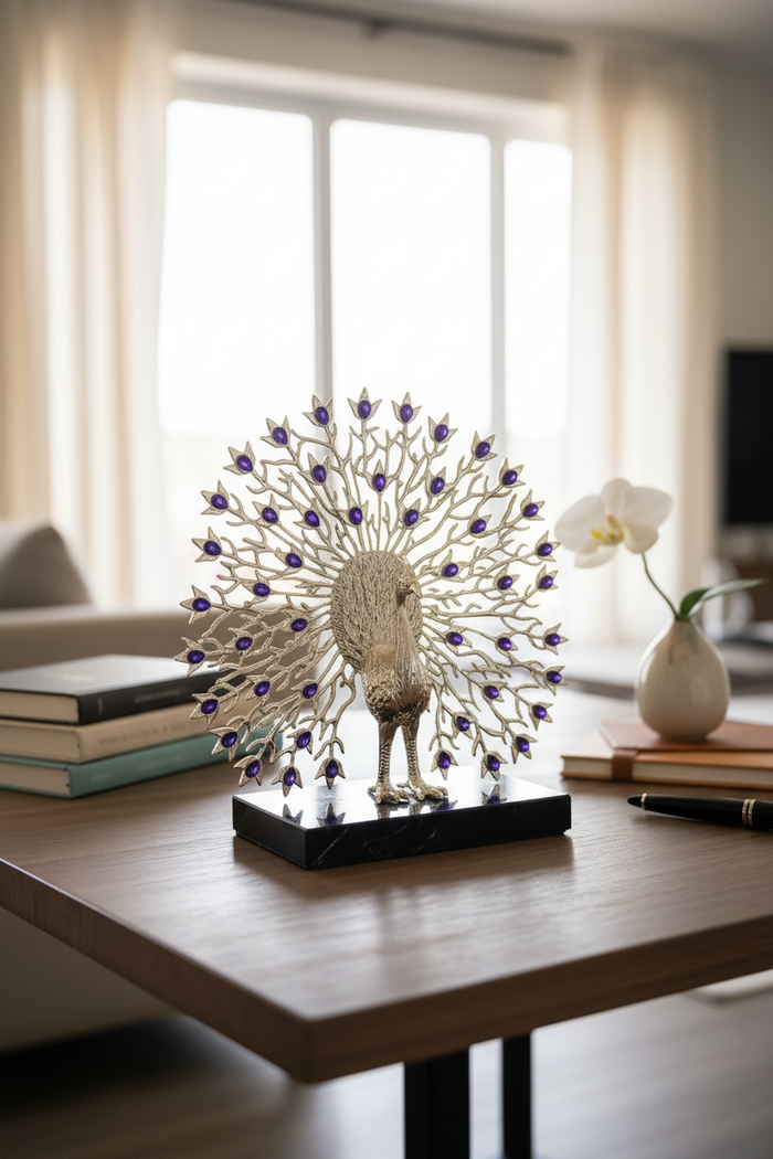 Elegant peacock sculpture with purple gem accents on wooden table, home decor accent piece