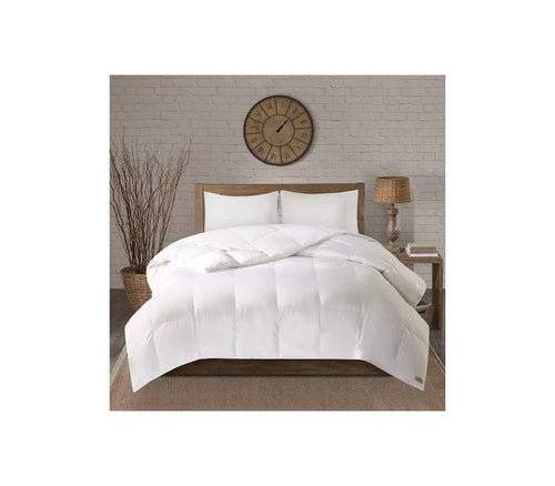 White quilted comforter on wooden bed frame with rustic decor, ideal for cozy bedrooms