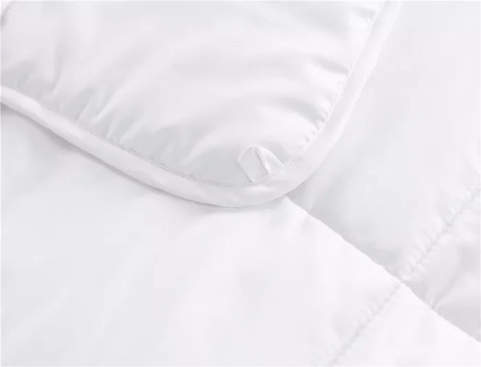 White quilted mattress protector with corner tie, ideal for bed frames and mattresses