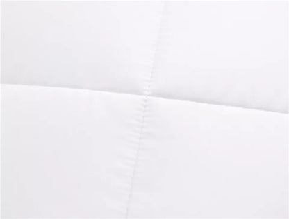 White quilted mattress protector with stitched detailing for cozy bedding comfort