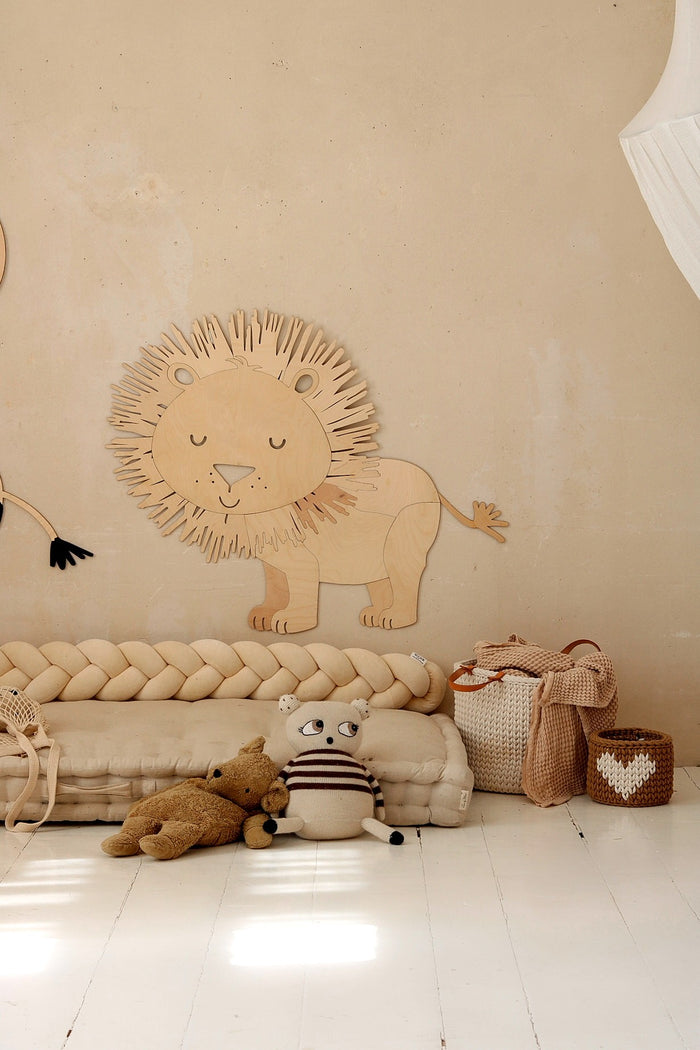 Safari lion wooden wall decoration positioned above rope floor mat in kids room