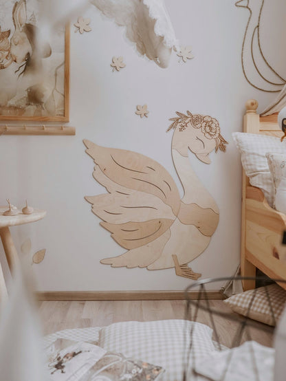 Full wooden swan wall decoration displayed in nursery with coordinating wooden furnishings and decor
