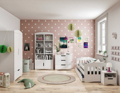 White kids nightstand displayed in pink polka dot bedroom with matching storage pieces