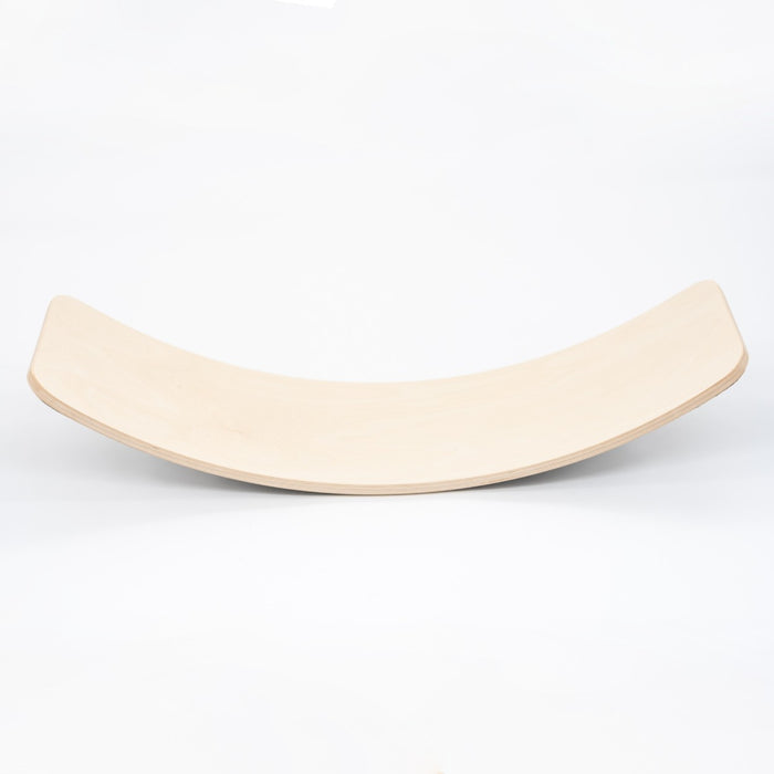 Natural wooden balance board with curved surface, side view on white background