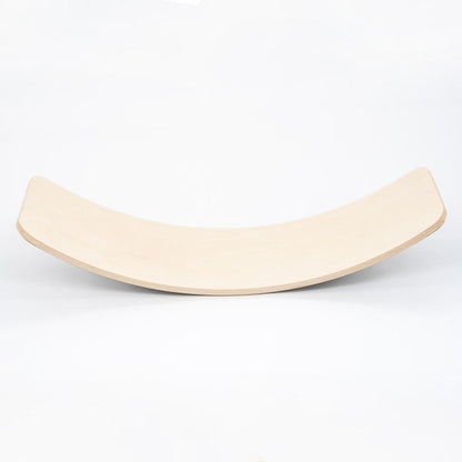 Natural wooden balance board with curved surface, side view on white background