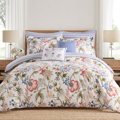 Floral bedding set on a bed with matching pillows in a bedroom setting.