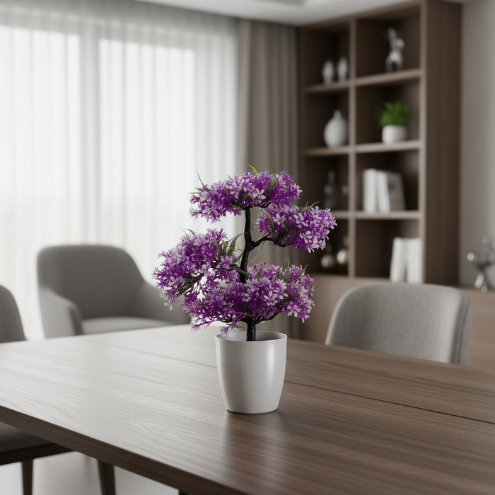 Purple flowering plant in white pot on modern dining table with grey chairs and shelving