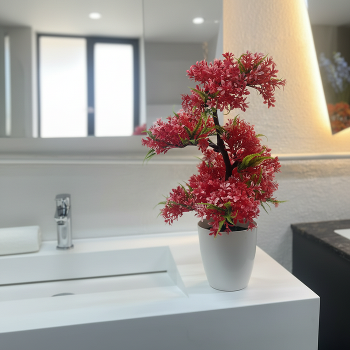 Red flowering bonsai in white pot on modern bathroom vanity, decorative home accent
