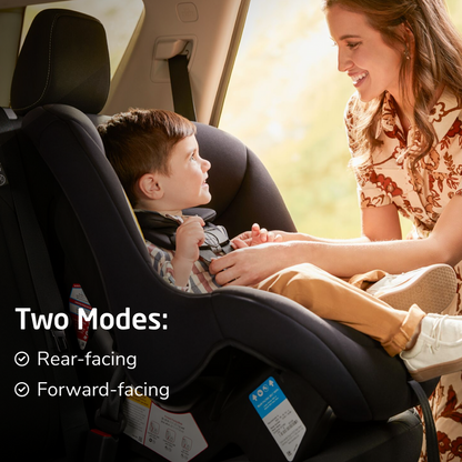 Woman adjusting a child in a car seat with text indicating two modes: rear-facing and forward-facing.
