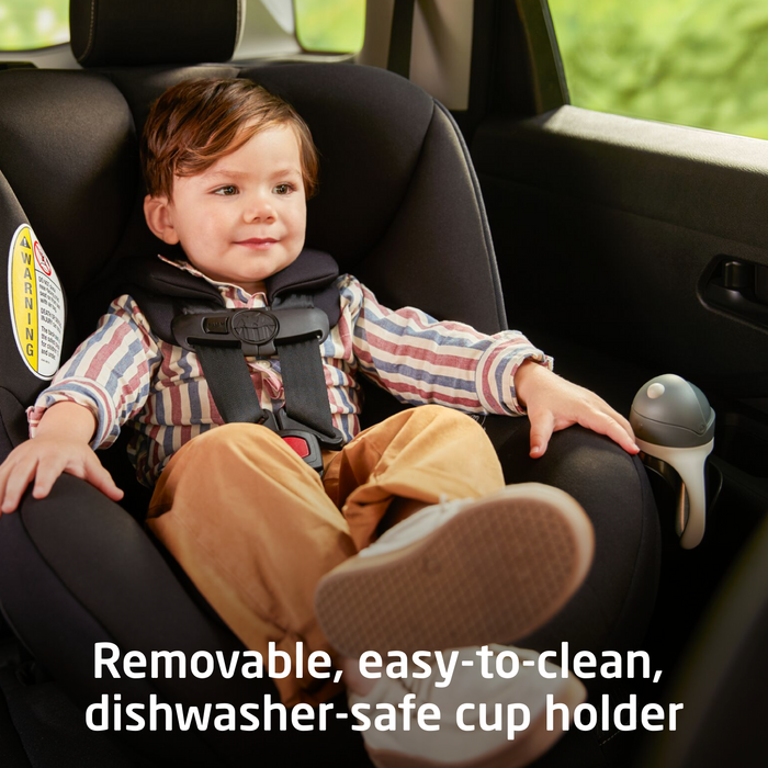 Child in a car seat with a cup holder in a vehicle interior