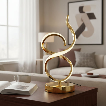 Modern gold sculptural table lamp on wood coffee table in stylish living room